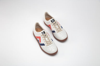 SA77A 颯合Pair of white sneakers with red and blue accents on a light gray background