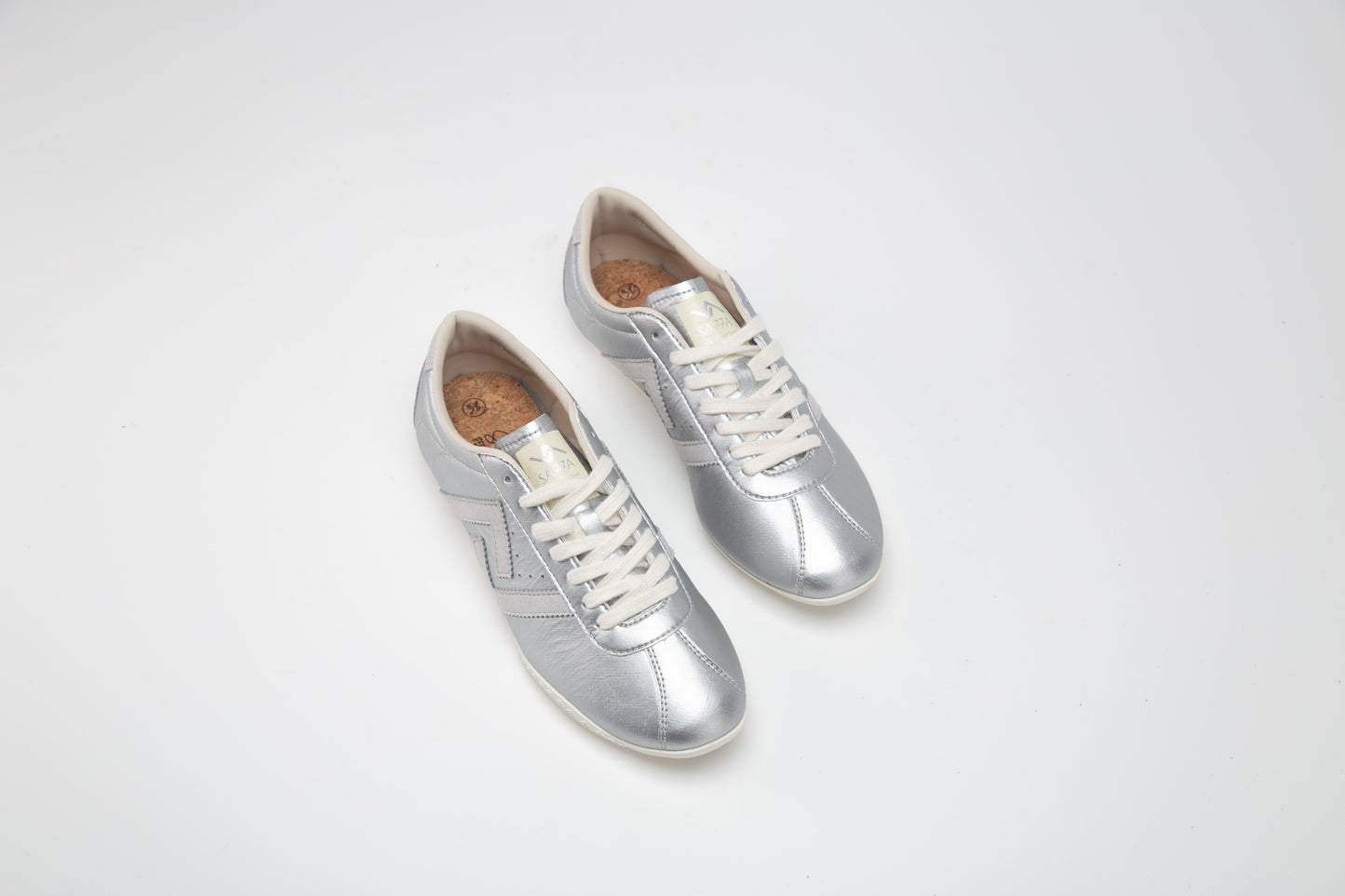 Sa77a颯合 AMOY COSMIC CHROME. The brand that spells H with double seven. Sa77a Sustainable sneaker. A pair of SA77A sustainable sneakers. silver sneakers on a light gray background
